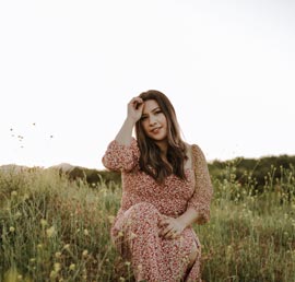 A photo of a Mexican woman wearing a brown long sleeve dress.